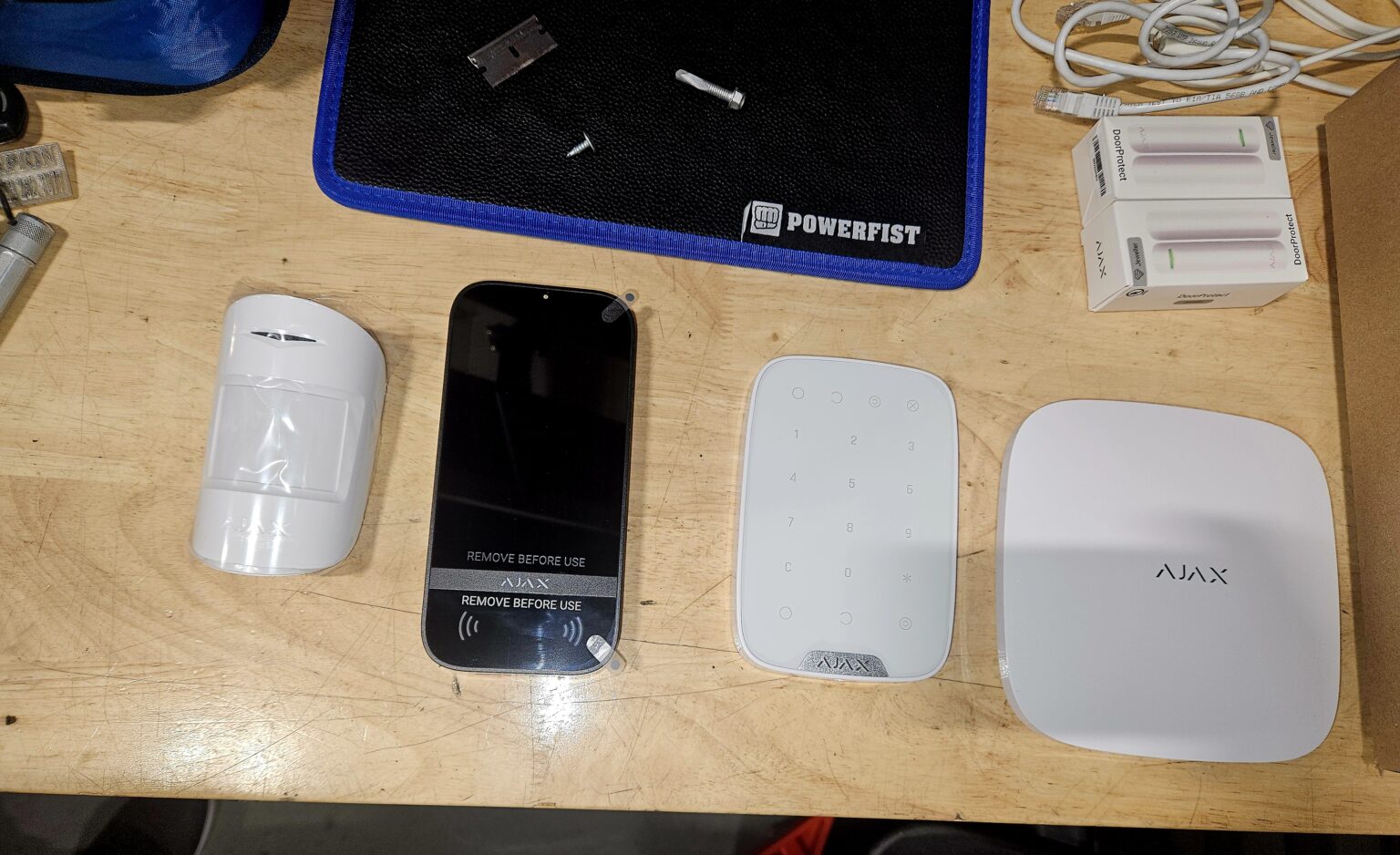 Ajax alarm system for an Ottawa auto repair shop: hub, motion detector, touchscreen keypad, keypad and door contacts, paired and tested before install