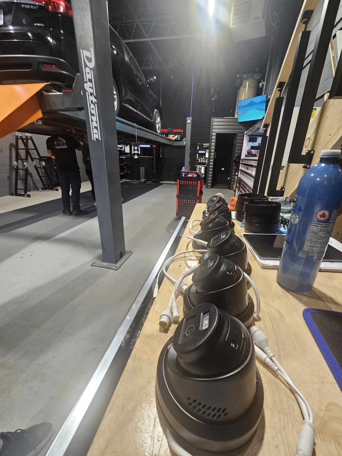 Dome security cameras prepped and tested on the bench before installation in an Ottawa auto shop