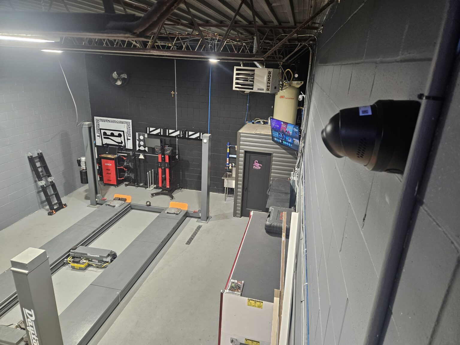 Commercial security camera installed in an Ottawa auto repair shop overlooking the service bays and lifts